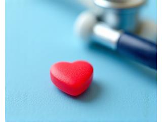 Heart-shaped pills and a stethoscope on a table